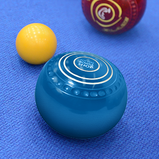 Two blue bowls and a yellow jack on a blue surface